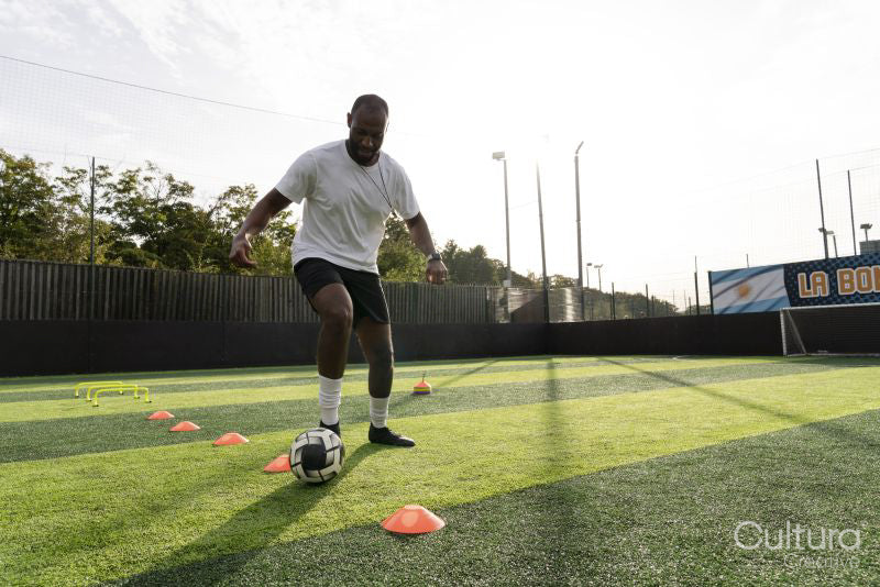 Soccer player practicing on soccer field