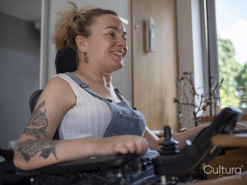 Smiling woman in electric wheelchair