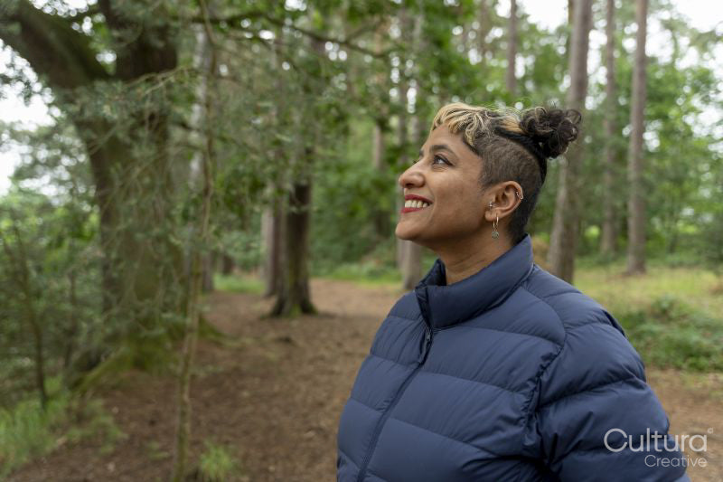 Smiling mature woman hiking in forest