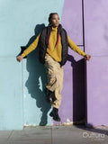 Portrait of young woman posing by colorful graffiti wall