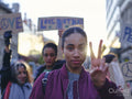 Activists holding peace signs protesting in street