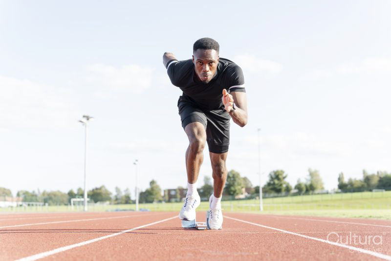 Athlete sprinting off at running track