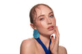 Studio portrait of a woman in a blue dress and large blue earrings