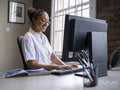 Teenage girl using computer in office