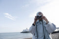 Portrait of Muslim woman photographing with analog camera