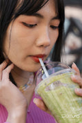 Close-up of young woman drinking sweet drink