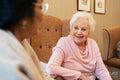 Smiling senior woman looking at friend while talking