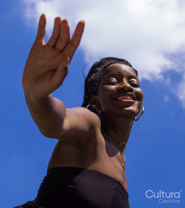 Portrait of young woman under blue sky