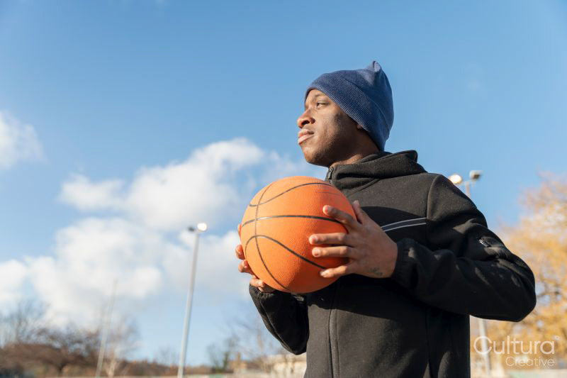 Portrait of man with basketball ball outdoors