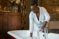 Senior woman making bubble bath