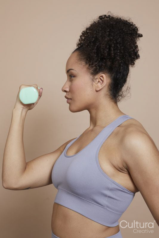 Studio shot of woman exercising with dumbbells