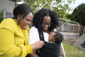 Mother and grandmother with baby boy in garden