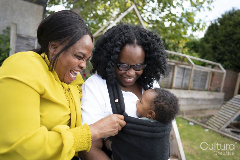 Mother and grandmother with baby boy in garden
