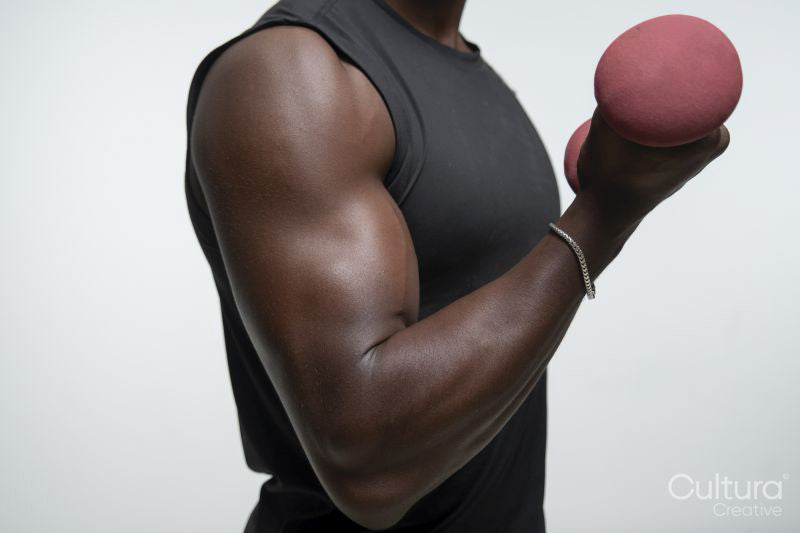 Man training arm with dumbbell