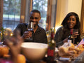 Man and woman drinking red wine at Thanksgiving dinner
