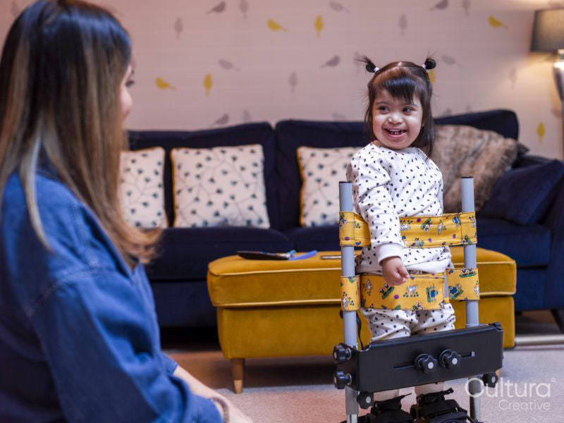 Girl in standing frame smiling to mother