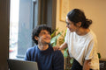 Man and woman using laptop in office