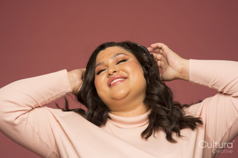 Studio shot of smiling woman with headphones