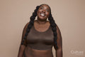 Studio shot of smiling young woman with braided hair