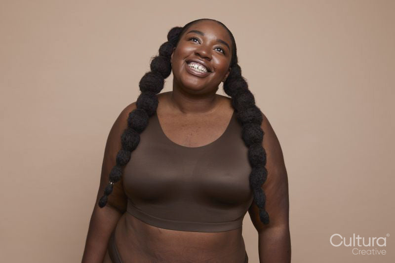 Studio shot of smiling young woman with braided hair