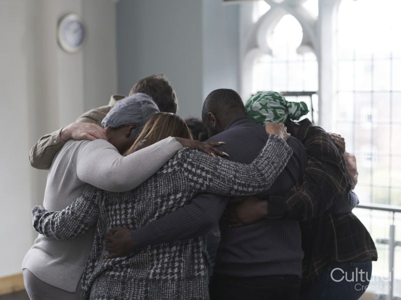 People hugging in group therapy session