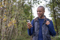 Man using smart phone during hike in autumn
