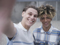 Smiling male couple taking selfie