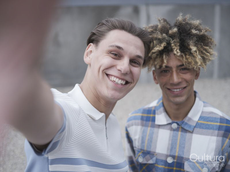 Smiling male couple taking selfie