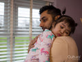 Father hugging sleepy daughter