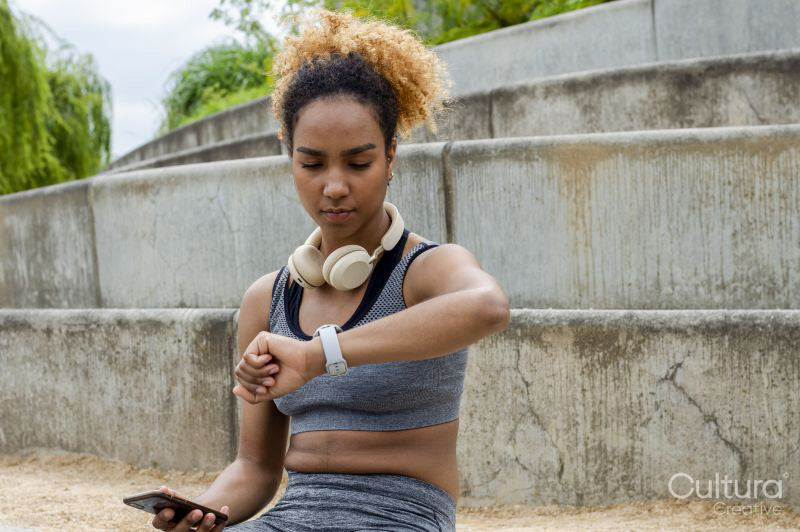 Sporty woman checking time on wristwatch