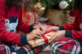 Close-up of sisters unpacking Christmas gift