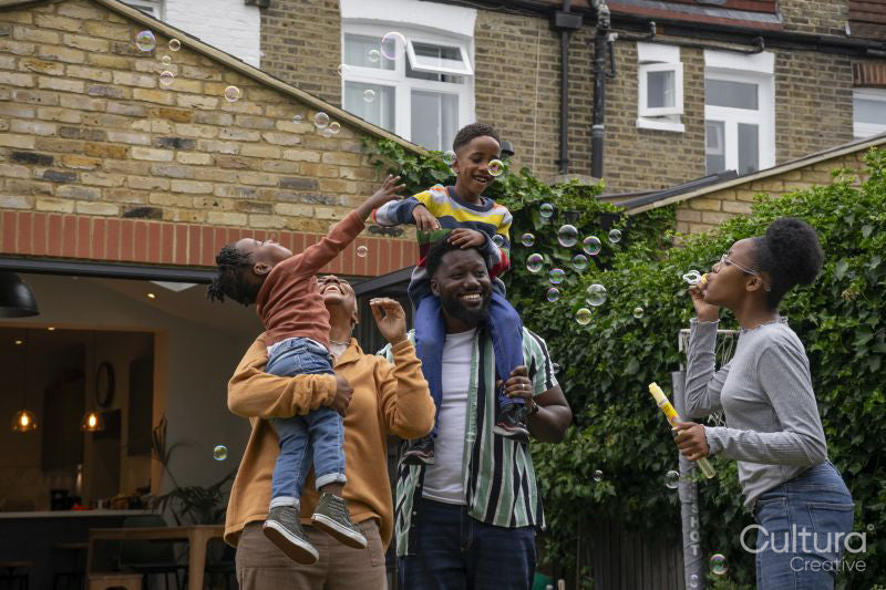 Family with children playing with soap bubbles