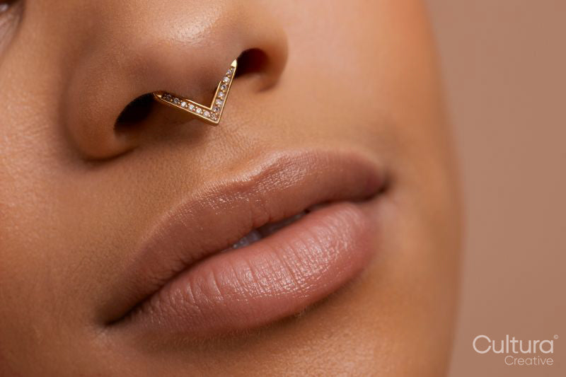 Close up portrait of non binary persons lips and pierced nose