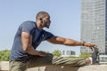 Mid adult man stretching in urban setting
