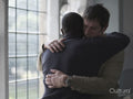 Men hugging in therapy session