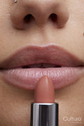 Close-up of young woman applying lipstick