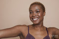 Studio portrait of smiling woman wearing bra