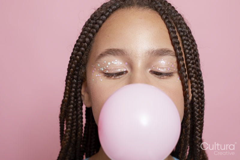 Close-up of girl blowing bubble gum