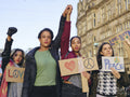 Activists holding peace signs protesting in street