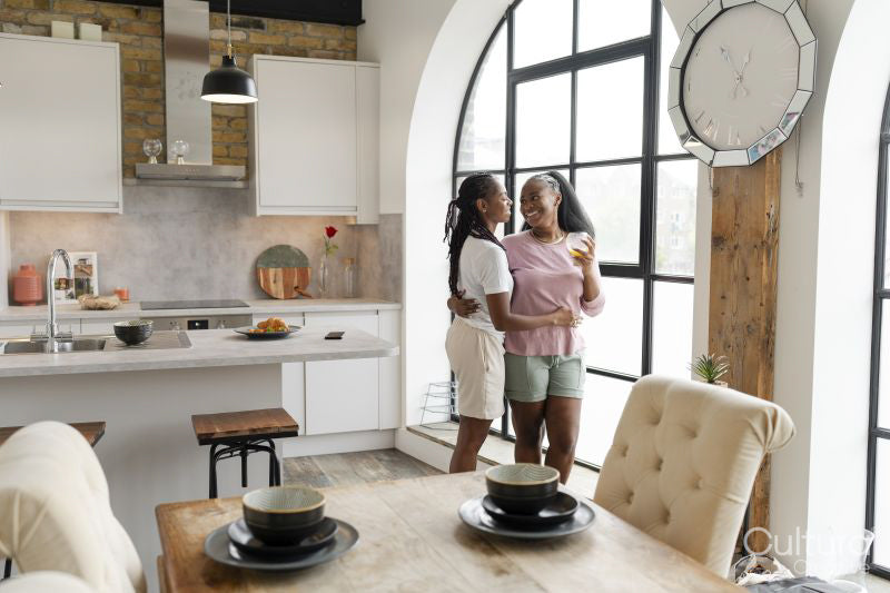 couple embracing while standing in kitchen
