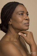 Studio portrait of mature woman with braided hair