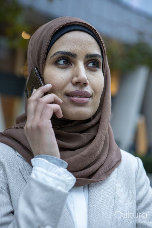 Portrait of businesswoman in hijab talking on smart phone