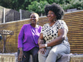 Two women relaxing in backyard