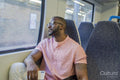 Man sitting in train and looking through window