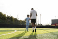 Rear view of coach and girl on soccer field