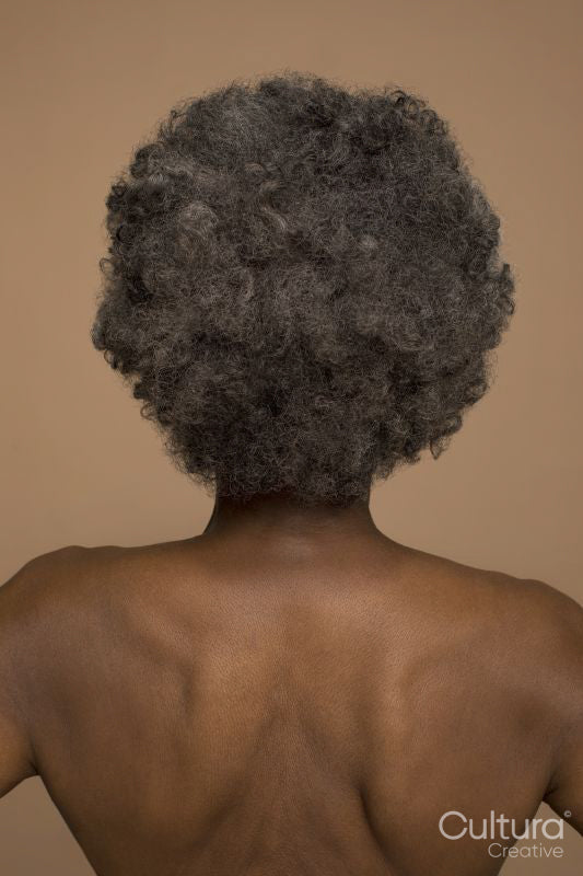 Rear view of shirtless senior woman
