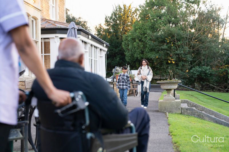 Family visiting senior man at nursing home