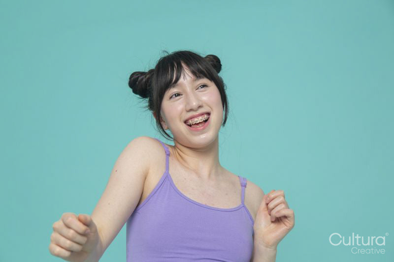 Studio portrait of smiling girl gesturing