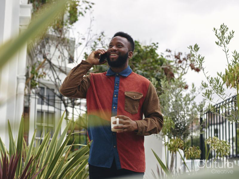 Smiling man talking on smart phone outdoors