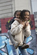 Portrait of boy giving piggyback ride to younger brother